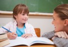 child-writing-teacher-alamy