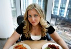 a_beautiful_woman_eating_food_from_a_bowl_1340129520